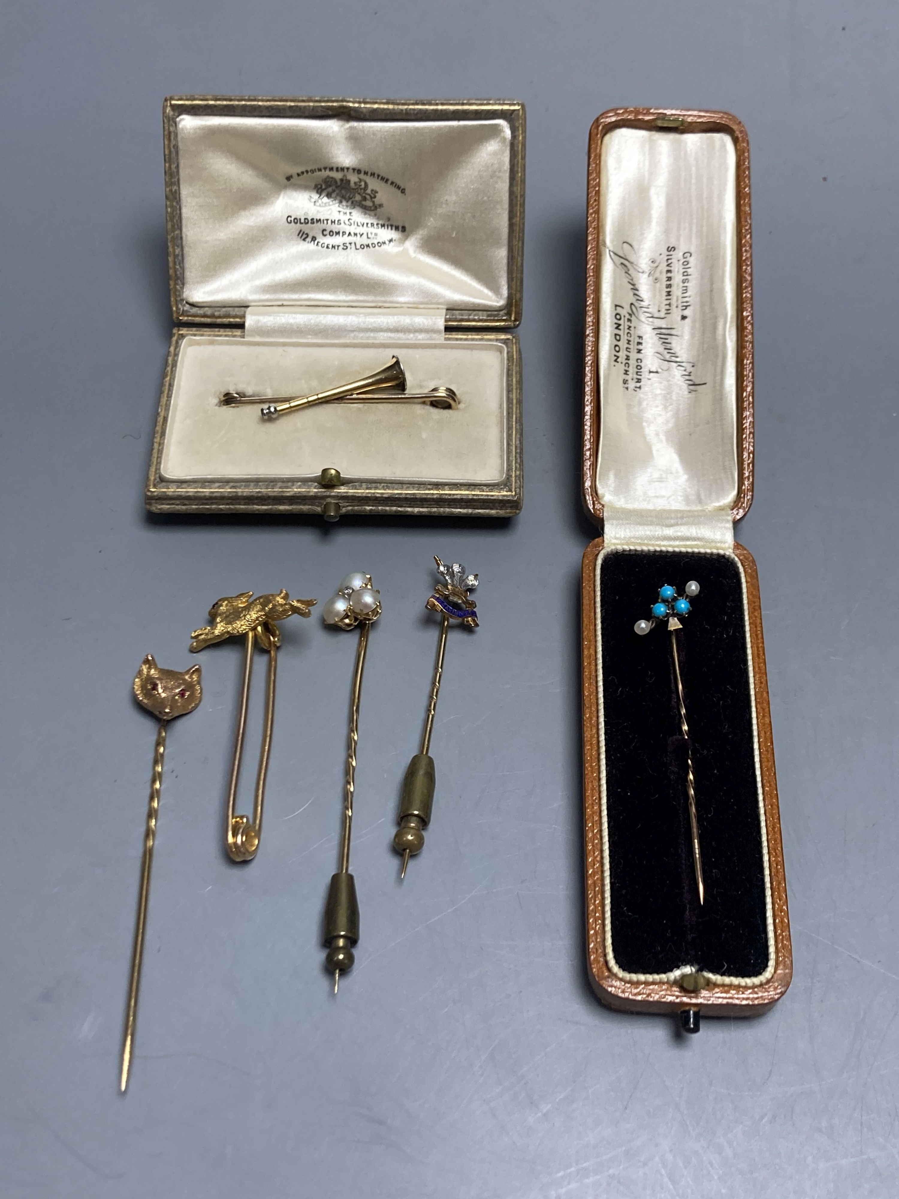 Four assorted late Victorian yellow metal stick pins and two tie pins.